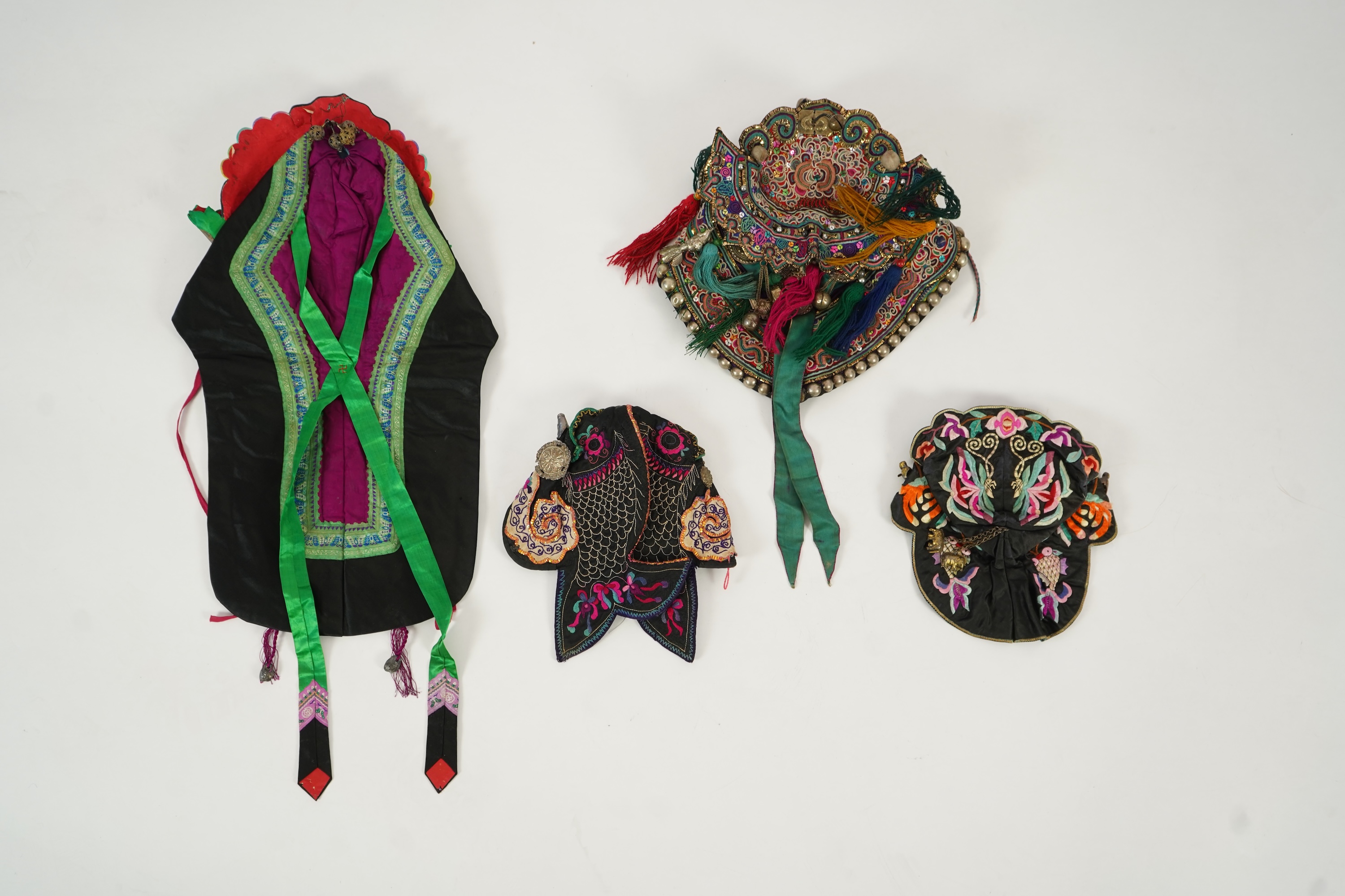 Two Chinese embroidered silk wedding skirts, late Qing, five hats, trousers, two skirt panels and two others, collar and a panel